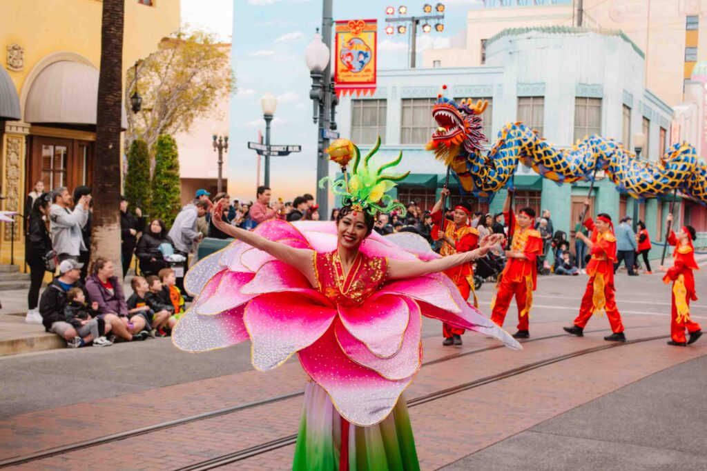 Woman in a lotus flower costume during a parade celebrating Lunar New Year, the year of the dragon, at California Adventure
