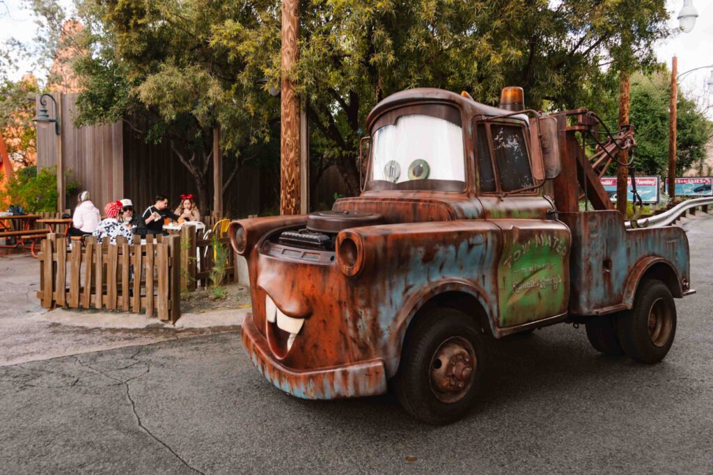Tow Mater in Cars Land driving around, one of the Disney Pixar characters you can meet at California Adventure